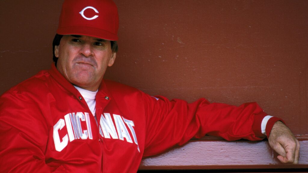 Pete Rose Net Worth celebrating a hit during a baseball game.